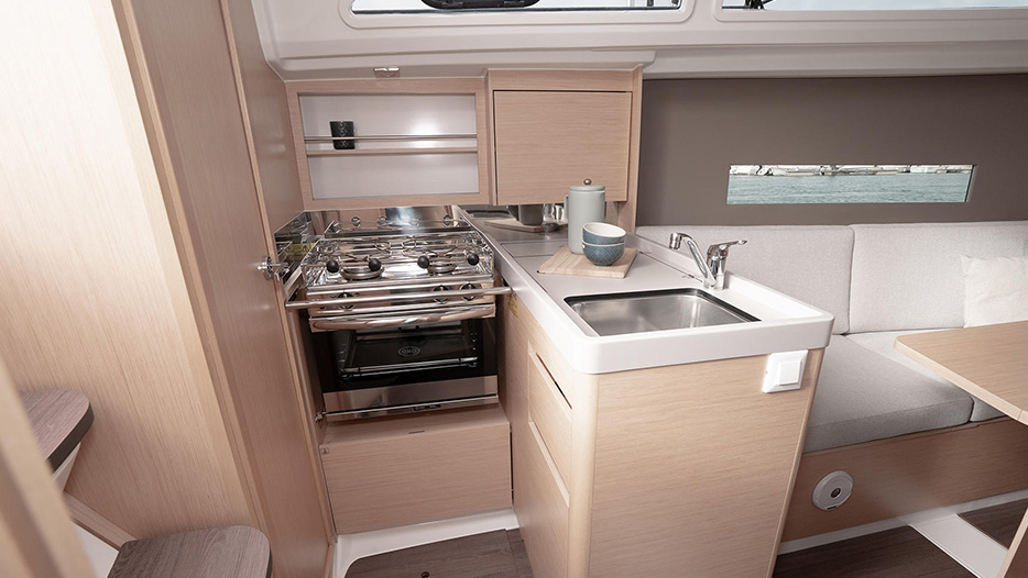 Beneteau 30.1 kitchen with stove, sink, and microwave